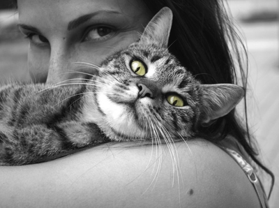 WOMAN HOLDING TABBY CAT